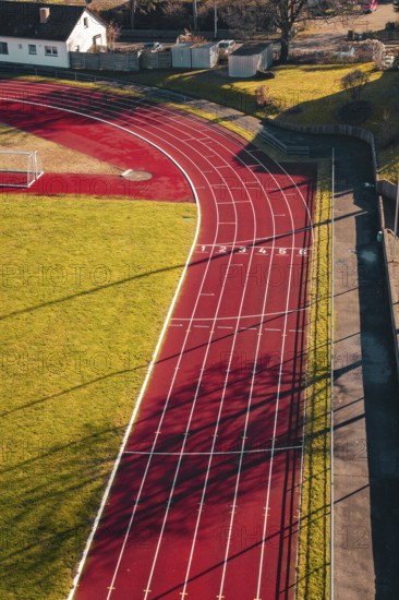Close view of a red track with numbered tracks and cast shadows, Wimberg, Calw, Germany