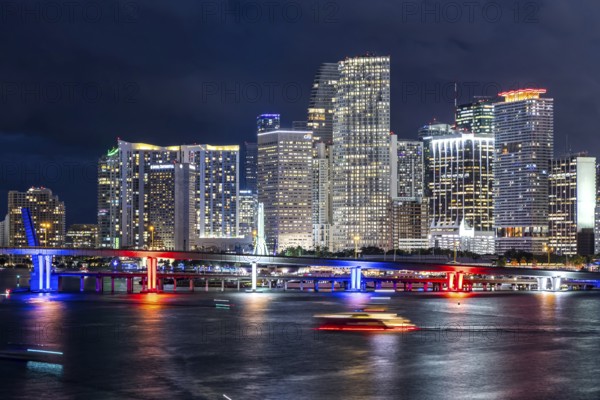 Miami skyline with high-rise real estate in downtown by the ocean at night in Miami, USA