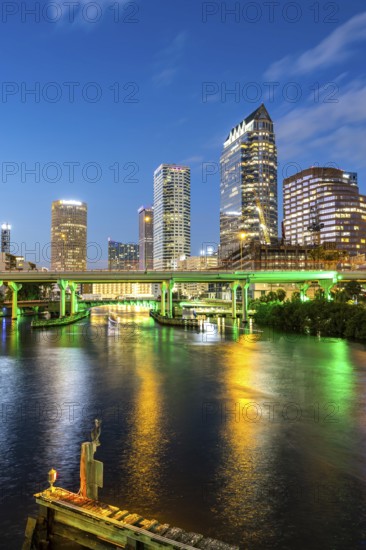 Tampa skyline with skyscrapers and bridge over Hillsborough River at night in downtown Tampa, USA