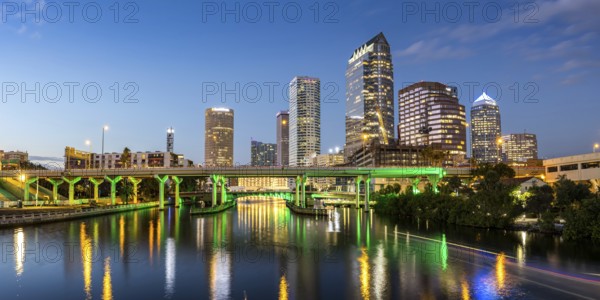 Tampa skyline with skyscrapers and bridge over Hillsborough River panorama at night in downtown Tampa, USA