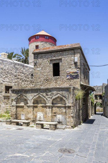 Ottoman fountain and windmill in the historic old town from the Middle Ages on the island of Rhodes, Greece