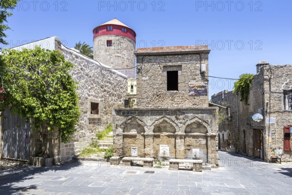 Ottoman fountain and windmill in the historic old town from the Middle Ages on the island of Rhodes, Greece