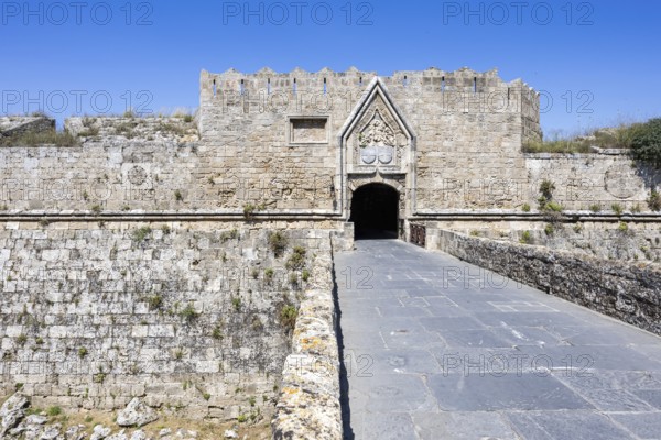 Red gate from the Middle Ages in the city wall of the historic old town on the island of Rhodes, Greece