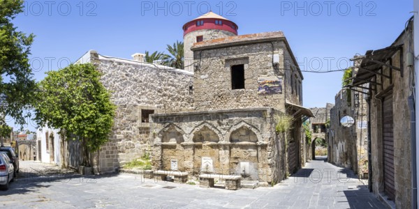 Ottoman fountain and windmill in the historic old town from the Middle Ages panorama on the island of Rhodes, Greece