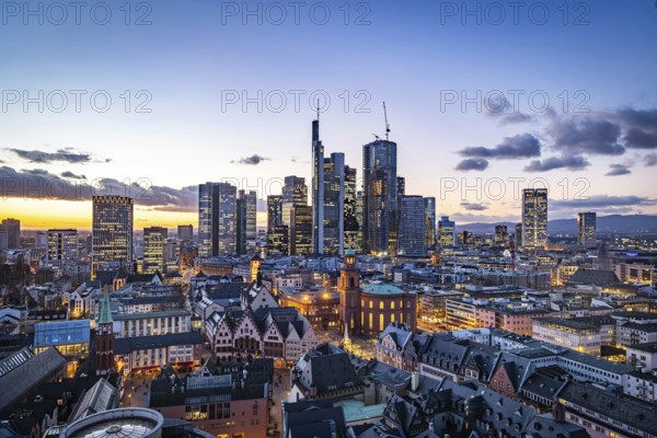 View of Frankfurt's banking district in the evening, city center and Mainhatten's skyscrapers are illuminated. Afterglow. Frankfurt am Main, Hesse, Germany