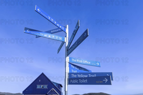 Greenland Ilulissat signs that show location of Ilulissat city and services