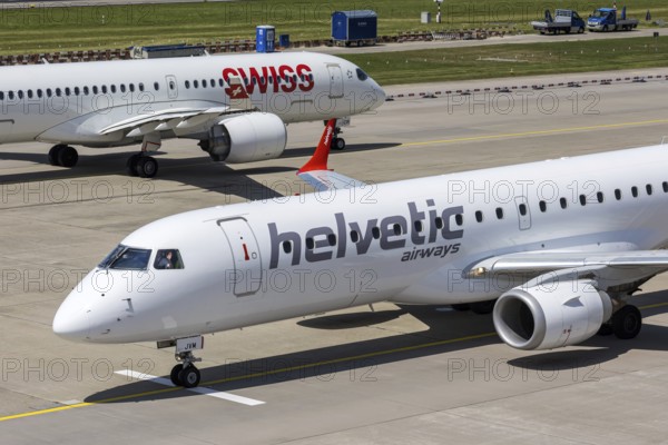 Embraer 190 and Airbus A220-300 Helvetic Airways and Swiss aircraft with the HB-JVM license plate at Zurich Airport, Switzerland
