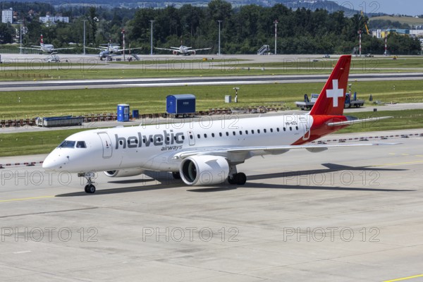 An Embraer 190 E2 Helvetic Airways aircraft with the HB-AZG license plate at Zurich Airport, Switzerland