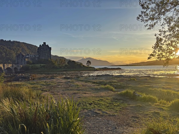 Castle in picturesque landscape at sunset with water and mountains, Highlander, film location, Dornie, Eilean Donan Castle, Scotland, Great Britain