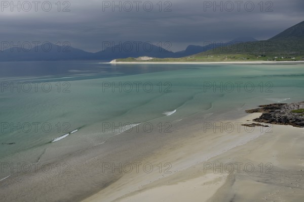 Wide sandy beaches under dark skies with calm seas and mountains, Outer Hebrides, Hebrides, Isle of Harris, Scotland, Great Britain