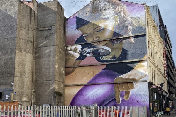 Large wall painting of a woman with magnifying glass in an urban setting, mural, street art, Glasgow, Scotland, United Kingdom