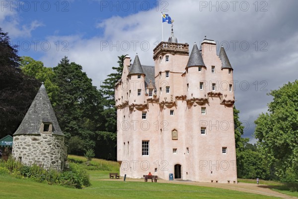 Pink castle with several towers under mostly blue sky, Craigievar Castle, Aberdeenshire, Scotland, United Kingdom
