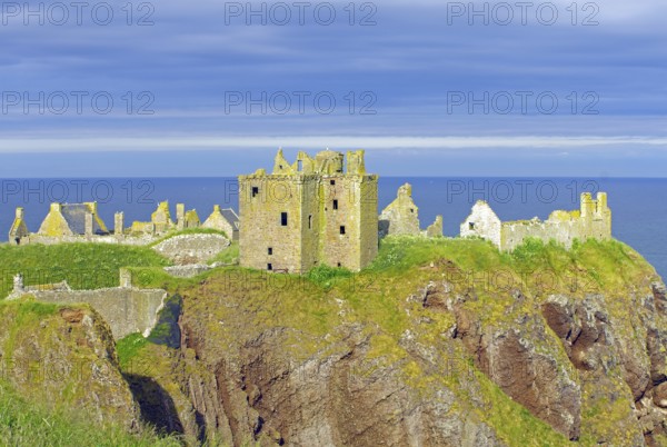 Old castle ruins on a cliff above the sea under a blue sky, Dunnottar Castlle, Stoneheaven, Aberdeenshire, Scotland, United Kingdom