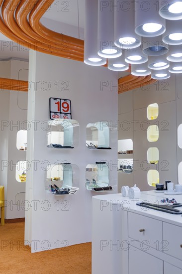Futuristic interior with orange and white elements and unusual lighting design