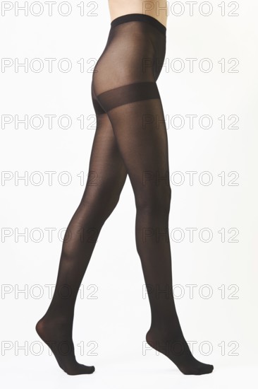 Unrecognizable woman walking on tiptoes in sheer butt lifting pantyhose isolated on white background