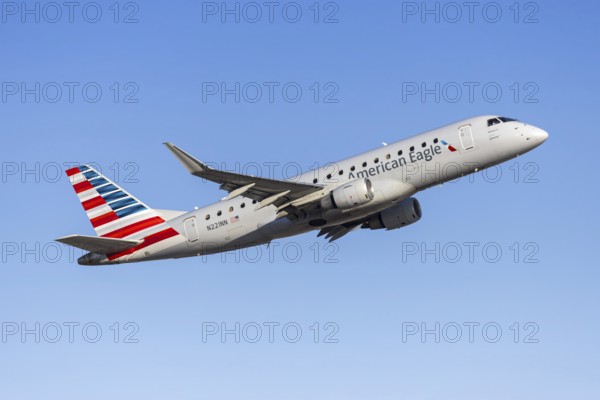 An American Eagle Embraer 175 aircraft operated by Envoy Air with license plate N221NN at Phoenix airport, USA