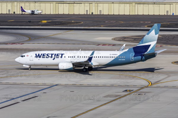 A Westjet Airlines Boeing 737-800 aircraft with the license plate C-FRWA at Phoenix airport, USA