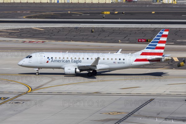 An American Eagle Embraer 175 aircraft operated by Envoy Air with license plate N317TB at Phoenix airport, USA
