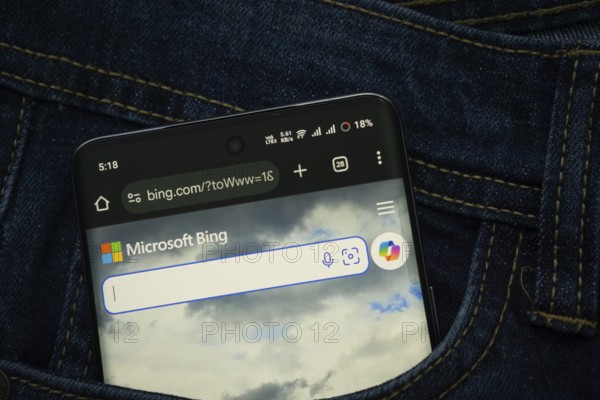 Dhaka, Bangladesh- 15 June 2025: A smartphone displaying the Microsoft Bing web interface peeks out of a denim pocket