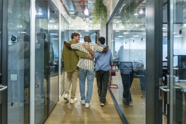 Diverse business colleagues walking together down a modern office corridor, reflecting teamwork, friendship, and a positive work environment during their break