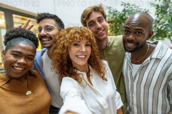 Diverse and happy colleagues pausing from work for a casual meeting or teamwork moment, showing collaboration and camaraderie in a vibrant office environment