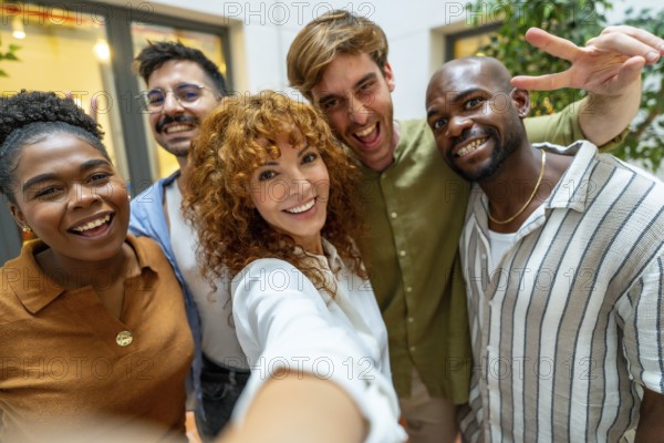 Happy business colleagues enjoying teamwork and a moment together, depicting diversity and collaboration in a modern office or coworking space during a break