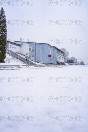 A snowy building with bare trees, quiet winter atmosphere, Gechingen, Calw district, Germany