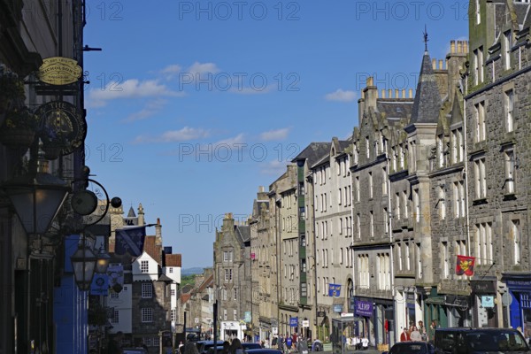 A street with Georgian buildings under a clear blue sky, Royal Mile, Edinburgh, Scotland, United Kingdom