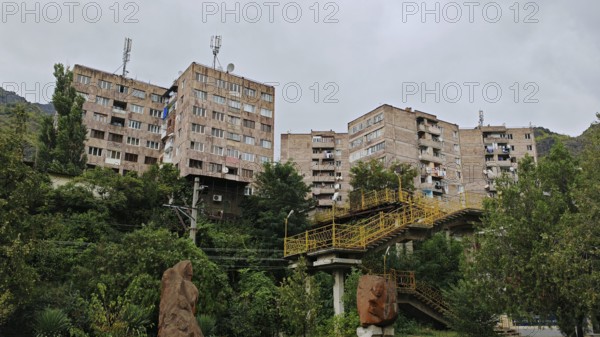 Several prefabricated residential buildings surrounded by nature and clouds, Alaverdi, Debed Canyon, Armenia