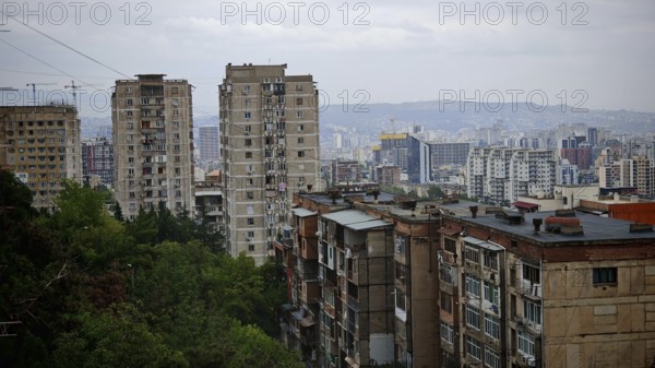 Urban panorama with high-rise buildings in a residential district of Tbilisi and hilly landscape, Tbilisi, Georgia