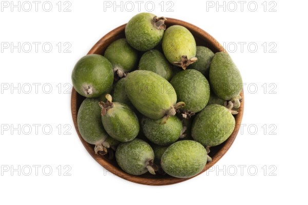 Ripe Feijoa in wooden bowl isolated on white background, top view, flat lay, close up, minimalism