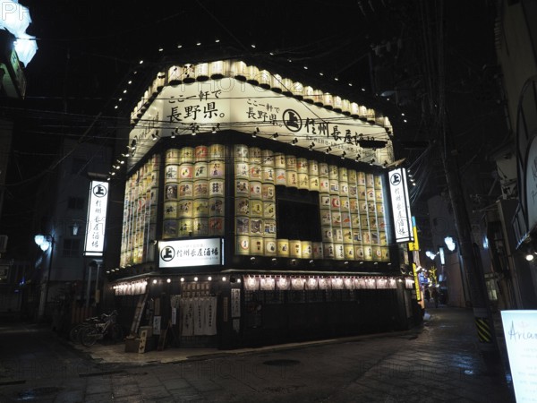 Traditional restaurant at night with glowing lanterns and signs, Japanese atmosphere, Nagano, Japan