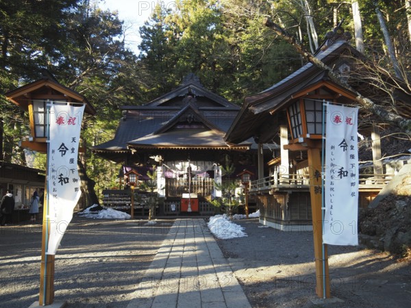 Traditional shrine surrounded by trees with wooden buildings and lanterns, Arakura Fuji Sengen-jinja Shrine, Kawaguchiko, Japan