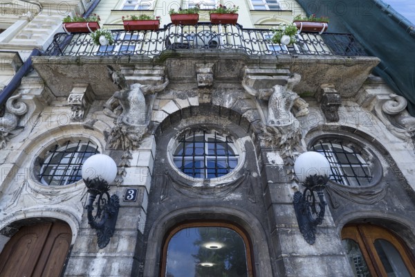 Dilapidated house with balcony supported by atlases, 19th century, Lemberg, Ukraine
