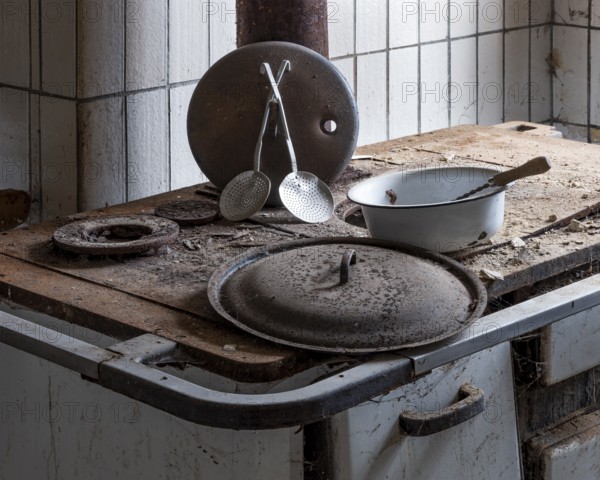 Rusted stove with kitchen appliances in the kitchen in an abandoned country inn, Lost Place, Saxony-Anhalt, Germany