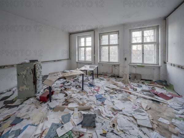 A room full of files lying around in an abandoned administration building, Lost Place, Saxony-Anhalt, Germany