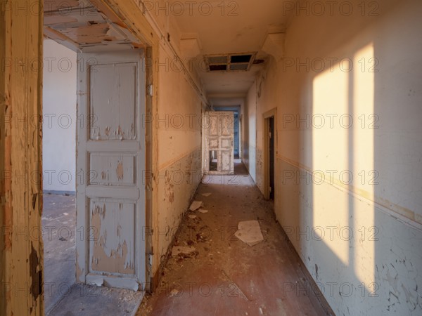 Corridor of an abandoned administration building in the light of the evening sun, Lost Place, Saxony-Anhalt, Germany