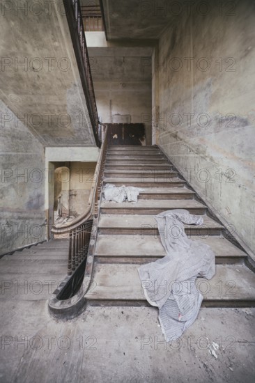 Staircase in a former children's recreation home in the GDR, curtains lie on the stairs, Lost Place, Saxony-Anhalt, Germany