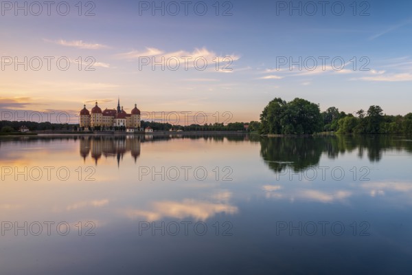 Moritzburg Castle, Augusts the Strong hunting lodge at dawn, water reflection in the lake, Saxony, Germany