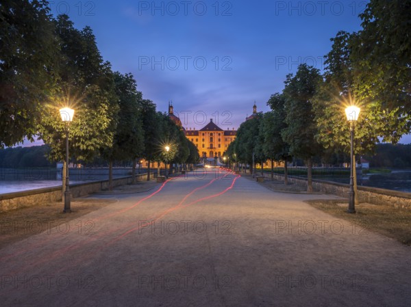 Avenue with lanterns as access to Moritzburg Castle, Augustus the Strong hunting lodge at dusk, Saxony, Germany