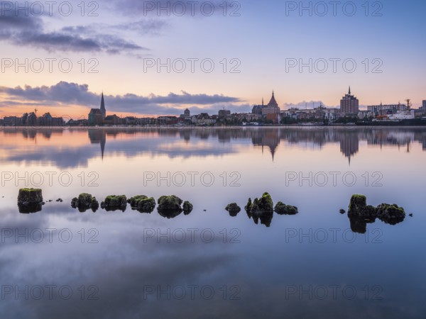 Old town and city port are reflected in the Warnow river, morning scene, Rostock, Mecklenburg-Western Pomerania, Germany