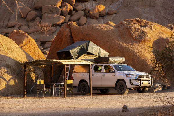 Camping vehicle with tent on rocky Spitzkoppe, Spitzkoppe, Namibia
