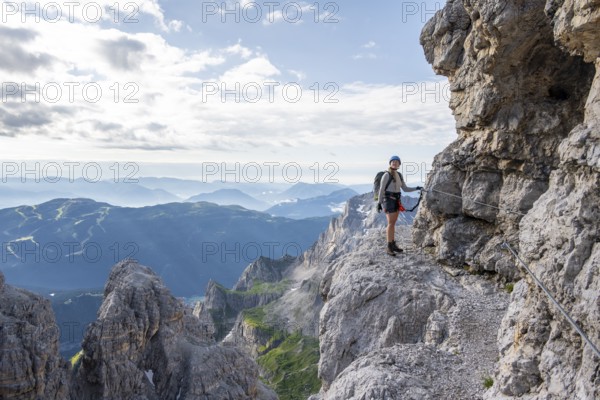 Climbers on a rock band, Bocchette Centrale band trail, via ferrata in the Brenta Mountains, Scharte Bocca di Tuckett, Parco Naturale Brenta-Adamello, Trentino, Italy