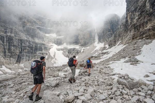 Hikers climbing the Via Ferrata Oliva Detassis, rocky mountain peaks and mountain scenery, Brenta Mountains, Brenta-Adamello Natural Park, Trentino, Italy