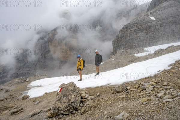 Mountaineers in a snowfield in fog, Brenta Mountains, Parco Naturale Brenta-Adamello, Trentino, Italy
