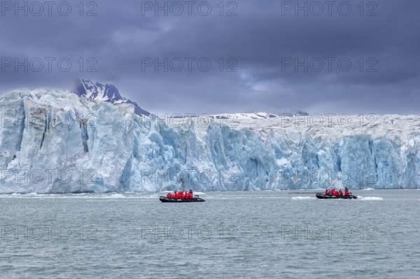 Boats with eco-tourists in front of Idabreen, Ida glacier calving into Liefdefjorden at Idabukta bay, Haakon VII Land, Spitsbergen, Svalbard, Norway
