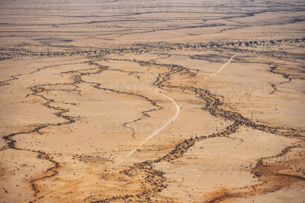 Extensive desert landscape with distinctive soil formations under clear skies, Spitzkoppe, Namibia