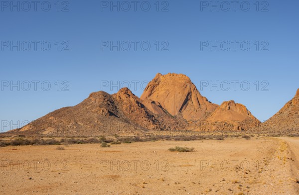Wide desert landscape with distinctive orange mountains, Spitzkoppe, Namibia