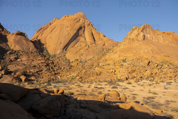 Wide view of impressive rocky mountains under a cloudless sky in Spitzkoppe, Spitzkoppe, Namibia