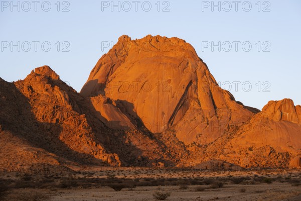 Impressive rocks in bright shades of red in the light of sunset near Spitzkoppe, Spitzkoppe, Namibia